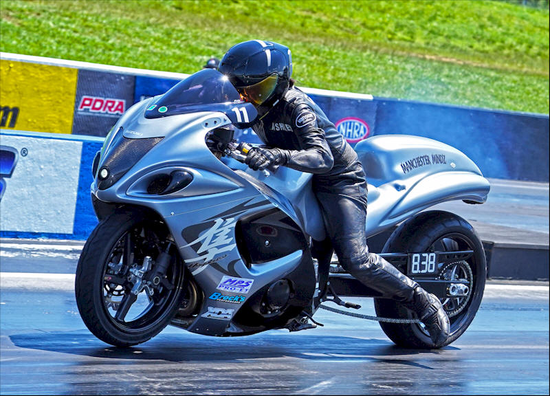 Real Street drag racer Ashley Cotnoir on her motorcycle at the XDA Superbike Showdown ready to take off down the track